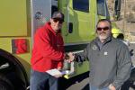 Chad LaVallee, Fire Chief with Alfalfa Fire District shakes hands with Prineville District Deputy Fire and Aviation Staff Officer Nathan Lefevre after receiving the keys for the wildland fire engine