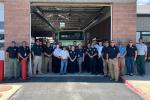 Ceremony attendees pose for a group photo in front of the water tender