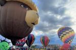 a wide angle view of Smokey Bear in hot air balloon form, surrounded by other hot air balloons