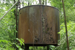 A hulking, rusted oil tank in overgrown forest in western Pennsylvania