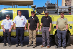 Five men stand in front a type 6 fire engine during transfer ceremony.