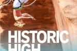 Slackliner upside-down on the line, text reading Historic High, Moab hosts first U.S. Slackline World Cup