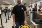 Man standing at airport counter with bags